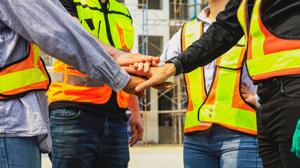 Team multi-ethnic workers, men and women, join hands to join forces to join forces to work for the...