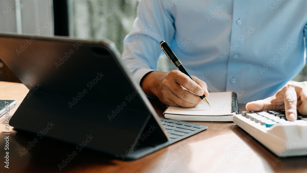 Aufkleber businessman hand working with new modern computer and writing on the notepad strategy diagram as con
