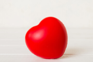 gift box with red bow and red heart on colored background. Perspective view. Flat lay