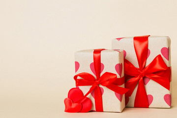 gift box with red bow and red heart on colored background. Perspective view. Flat lay