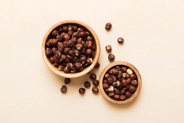 Wooden bowl full of hazelnuts on table background. Healthy eating concept. Super foods