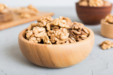 Fresh healthy walnuts in bowl on colored table background. Top view Healthy eating bertholletia concept. Super foods