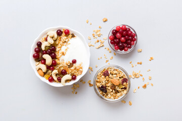 Healthy breakfast food with granola, yogurt, fruits and nuts. Dessert parfait with dried fruits for...