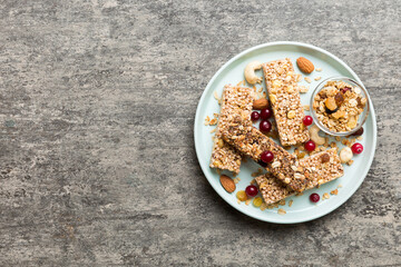 Various granola bars on table background. Cereal granola bars. Superfood breakfast bars with oats, nuts and berries, close up. Superfood concept