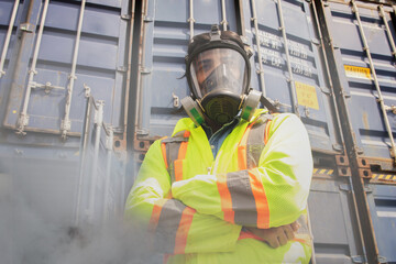 Male rescue worker wearing PPE suit standing with arms crossed wearing mask protect dangerous...