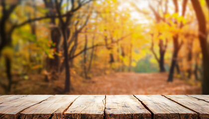 Wooden table top on blur dry forest in leaves fall autumn. Slowly time concept. perspective view. For montage product display or design key visual layout. View of copy space.