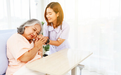 Female doctor holds the hand elderly female patient showing positive expressions encouragement good wishes each other heal sick person normal healthy spread happiness together in the hospital.