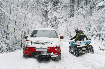 Car and atv in the snow