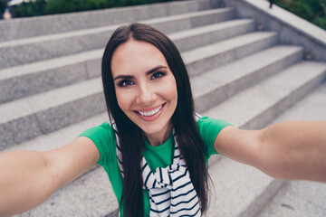 Portrait of cheerful lovely woman dressed stylish outfit recording video blog filming weekend day outdoors in town