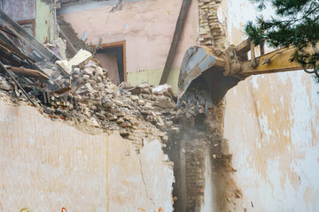 An excavator and other heavy construction equipment are working on the construction site. An...