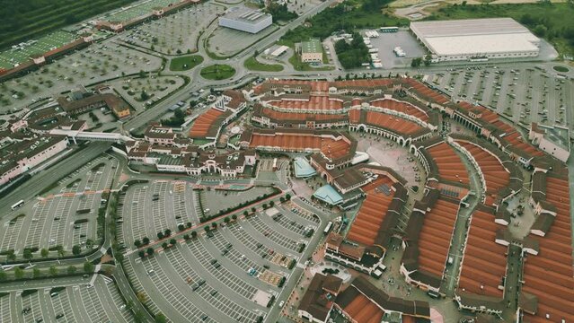 Aerial view of an outlet buildings and parking lots in Serravalle Scrivia, Italy