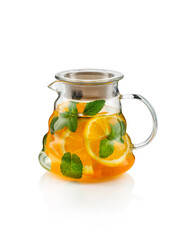 Fruit tea with oranges, mint  in a glass kettle ( teapot) on white
