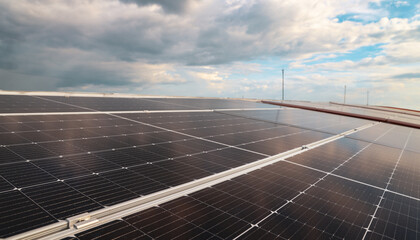 Picture of installing solar panels on the curved roof of an industrial factory modern technology...