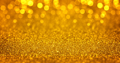 Sparkling golden glitter background with bokeh. Closeup view, dof. Pattern with shining fine gold...
