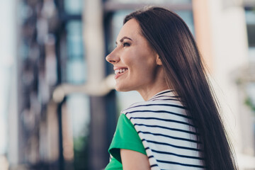 Photo of adorable good mood lady wear green t-shirt walking enjoying sunny weather outside urban city street