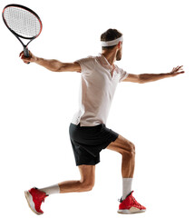 Concentered young man, tennis payer in motion during game, training, hitting ball with racket isolated over transparent background. Concept of sport, competition, action, winner, tournament, active