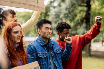 portrait of group of multiracial young people fighting for equality and peace with fists raised