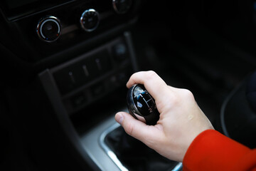 Close up view of a gear lever shift. Manual gearbox. Car interior details. Car transmission. Soft...
