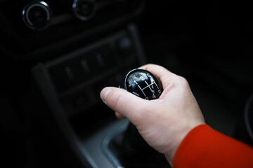 Close up view of a gear lever shift. Manual gearbox. Car interior details. Car transmission. Soft...