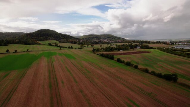 Aer ial view of a German town surrounded by meadows, farmland and forest in Germany.