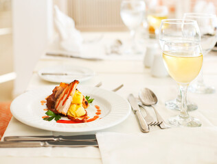 Dinner with white wine and meat