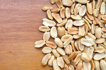 Peanut on brown wooden background.