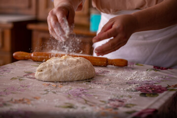 Cook's hands kneading dough for cakes. Preparing the flour for leavening