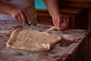 Cook's hands kneading dough for cakes. Preparing the flour for leavening