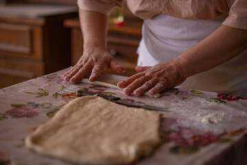 Cook's hands kneading dough for cakes. Preparing the flour for leavening