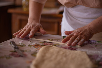 Cook's hands kneading dough for cakes. Preparing the flour for leavening