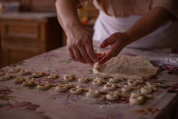 Cook's hands kneading dough for cakes. Preparing the flour for leavening
