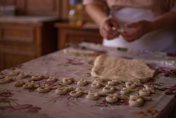 Cook's hands kneading dough for cakes. Preparing the flour for leavening
