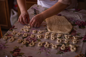 Cook's hands kneading dough for cakes. Preparing the flour for leavening