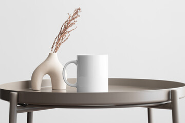 White mug mockup with a dry flower decoration on the beige table.