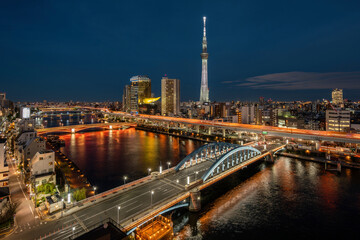 Tokyo cityscape with architectural landmark Tokyo Skytree and Sumida river at night in Tokyo, Japan. 