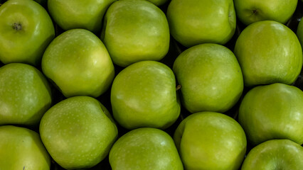 close up of green apple arrangement in a modern market or supermarket