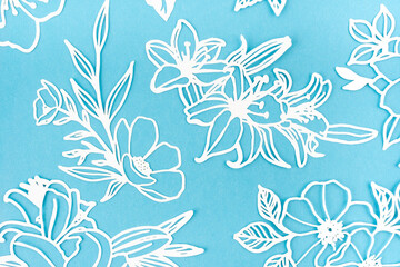 Fototapeta na wymiar White paper cut plants leaves on blue background