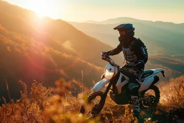 Fotobehang Motocross rider on the background of the mountains at sunset. Motocross. Enduro. Extreme sport concept. © John Martin