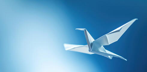 Paper crane on a blue background. The concept of peace and the traditional art of origami.
