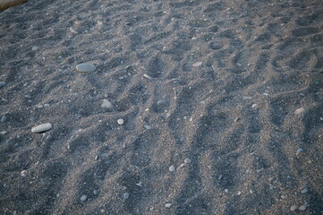 Sand with stones on the beach. Background image.