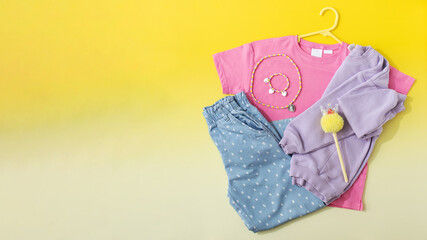A children's set of fashionable clothes. Stylish jeans, T-shirt and sweatshirt colored T-shirts for girls. Copy space