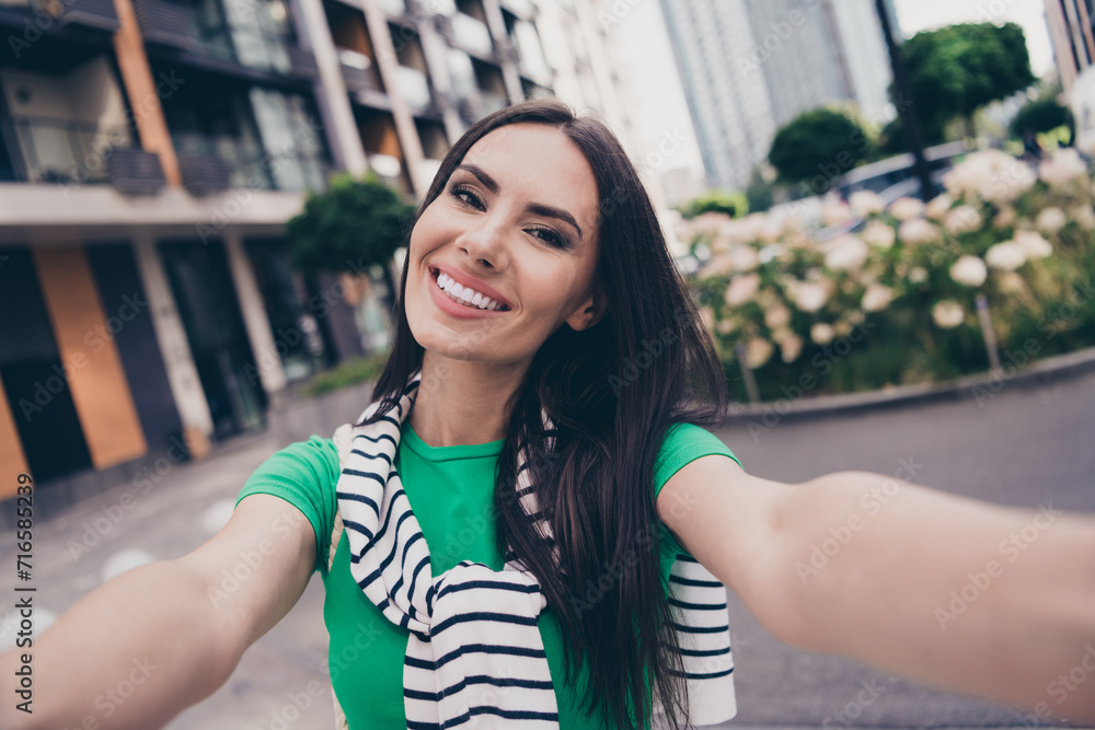 Sticker Selfie of young blogging girl recording video for subscribers walking street outside outdoors her city residential complex on background