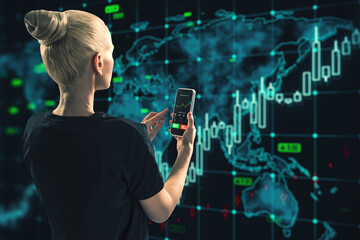 Back view of blonde woman using smartphone with glowing forex chart and map on dark background....