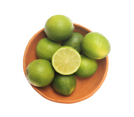 Green lemon in a clay bowl. Lemon from Brazil.