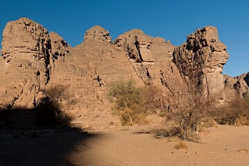Rock formations at Guelta Tikoubaouine in the tourist area of Immourouden, near the town of Djanet. Tassili n Ajjer National Park. Sahara desert. Algeria. Africa.