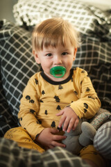 Fototapeta premium Tender moment between a happy cute baby boy and his favorite stuffed toy. Child concept