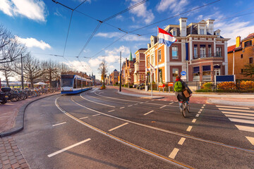 Winter Amsterdam street, Dutch flag against typical houses, Holland, Netherlands.
