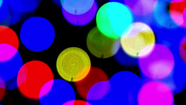 Defocused colorful flashing lights. Abstract background, design element or overlay.