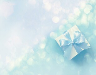 Blue pastel watercolour background with a birthday present. Copyspace, bokeh effect. 