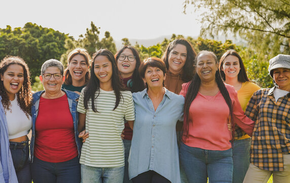 Group of multiracial women hugging each other at city park - Female community with different ages